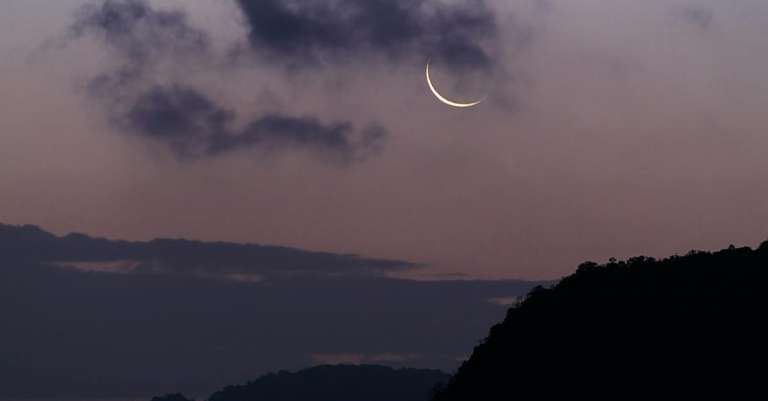silhouet-van-berg-onder-de-maan-bedekt-met-wolken-2